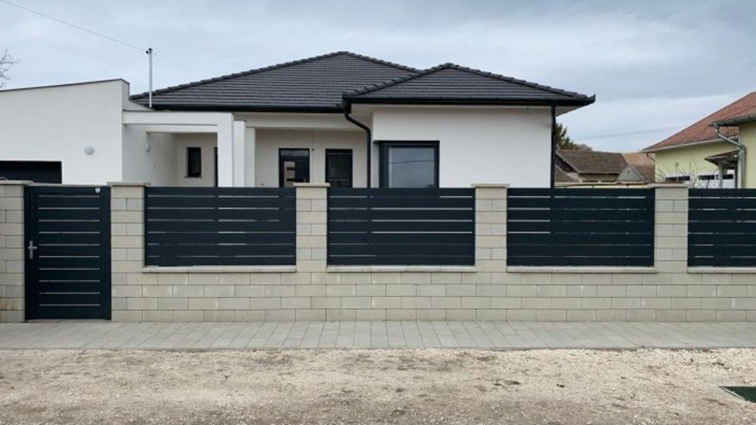 Guardi Triest Aluzaun anthrazit mit breiten Latten, modernes Flachdachhaus Einfahrt