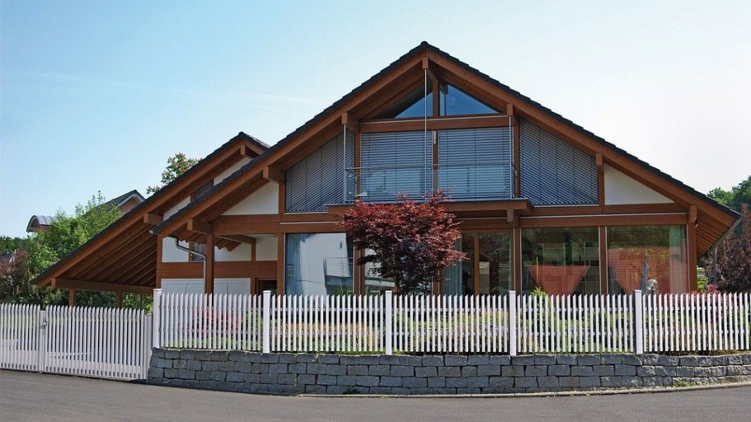 Guardi Treviso Alu-Jägerzaun weiß, modernes Holzhaus mit Glasfront Vorgarten